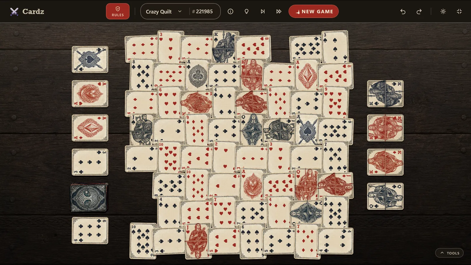 A game of Crazy Quilt in Cardz — a woven lattice of illustrated Valhalla cards on a dark wood table